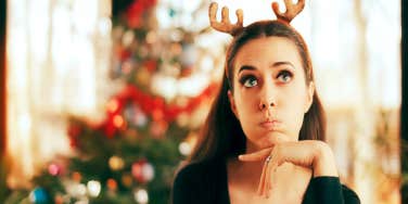unhappy woman in reindeer antlers