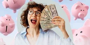 ecstatic woman holding a stack of cash