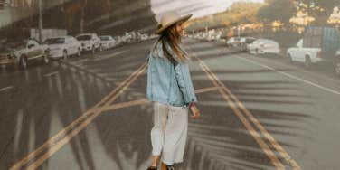 Woman walking down the middle of the road