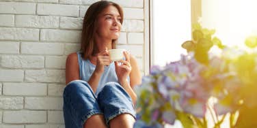 woman drinking coffee in sunshine