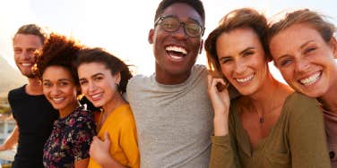 Portrait of smiling young friends walking outdoors together