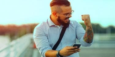 excited man on his phone sending flirty texts