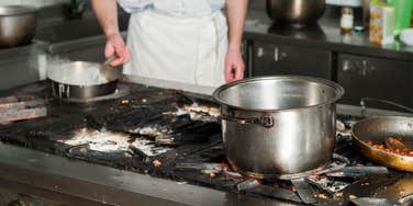 line cook cooks on dirty kitchen surface