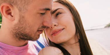 woman looking longingly at her forever person on the beach