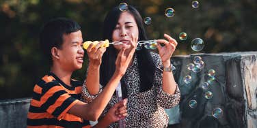 mom and son blowing bubbles