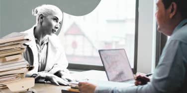 Woman meeting with a divorce lawyer, with paperwork 