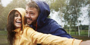 man and woman in raincoats in the rain