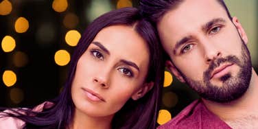 couple looking into the camera with serious expressions 