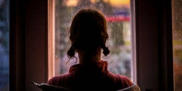 woman looking out a window