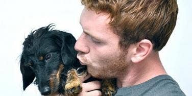 guy kissing dog