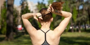 woman putting up a pony tail