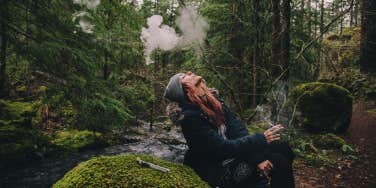 woman smoking in the woods