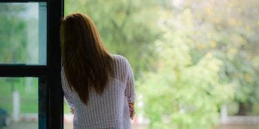 woman looking outside