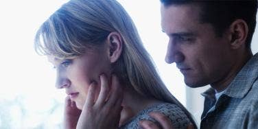 woman looking frustrated with husband over her shoulder