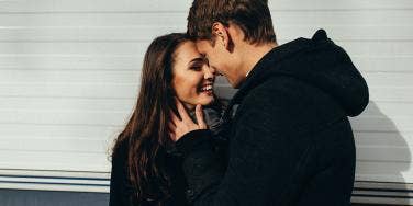 man and woman putting foreheads together 