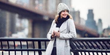 smiling woman in white coat 