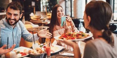 friends at a restaurant making healthy food substitutions