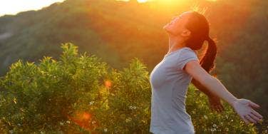 woman in the mountains with sunset 