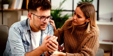 wife talking to her husband, who is crying