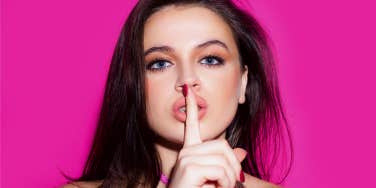 girl hushing with her finger