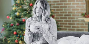 Sad woman in front of Christmas tree