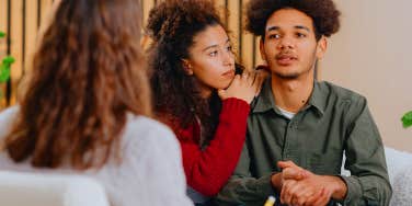 young couple talking to counselor 