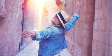 woman dancing down canyon