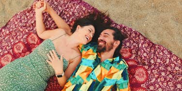 couple laying together on beach