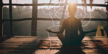 Woman meditating on balcony