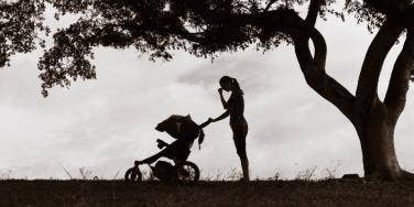 sad mother with baby in stroller