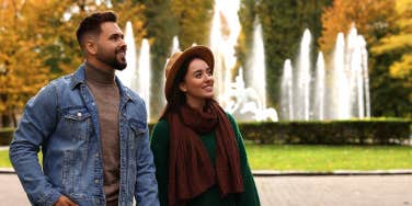 couple walking in park holding hands