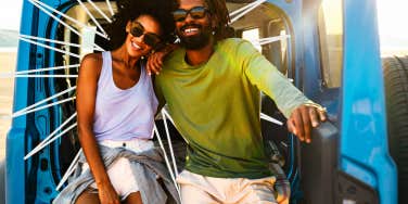 Couple sitting in the back of a jeep