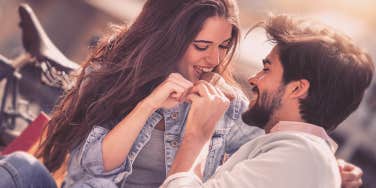 couple smiling eating cookie