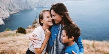 mom hugging a teen and a tween