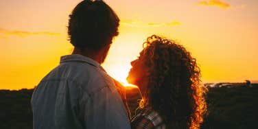 woman looking at man in sunset