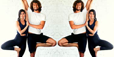 smiling man and woman in yoga pose