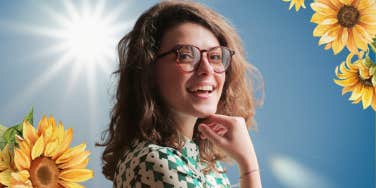 Woman smiling with sunshine in the background 