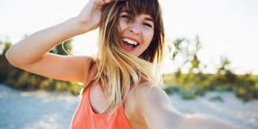 happy woman taking a photo of herself