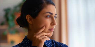 pensive woman looking out the window