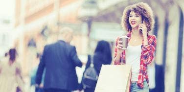 woman on the phone with shopping bags