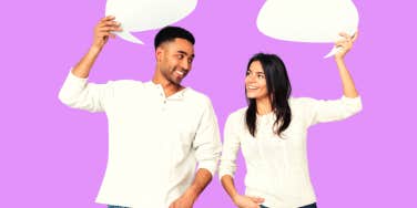 man and woman holding conversation bubbles in front of pinkish purple background