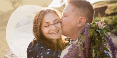 couple on the beach, man kissing her cheek