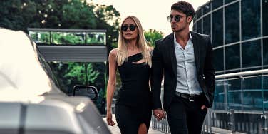 fancy couple dressed up walking holding hands