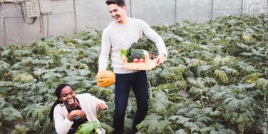 Flirty couple picking food in the garden 