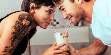 Couple sharing a milk shake 