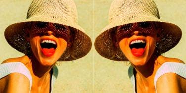 mirror image of woman in hat with her mouth open
