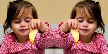 girl eating apples and honey on Rosh Hashanah