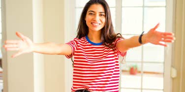 woman holding her arms wide open