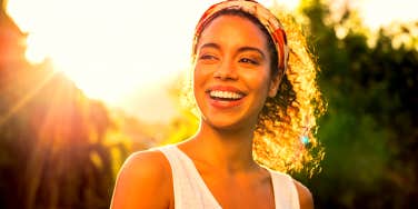 happy woman smiling in the sunlight
