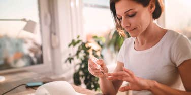 woman painting her nails